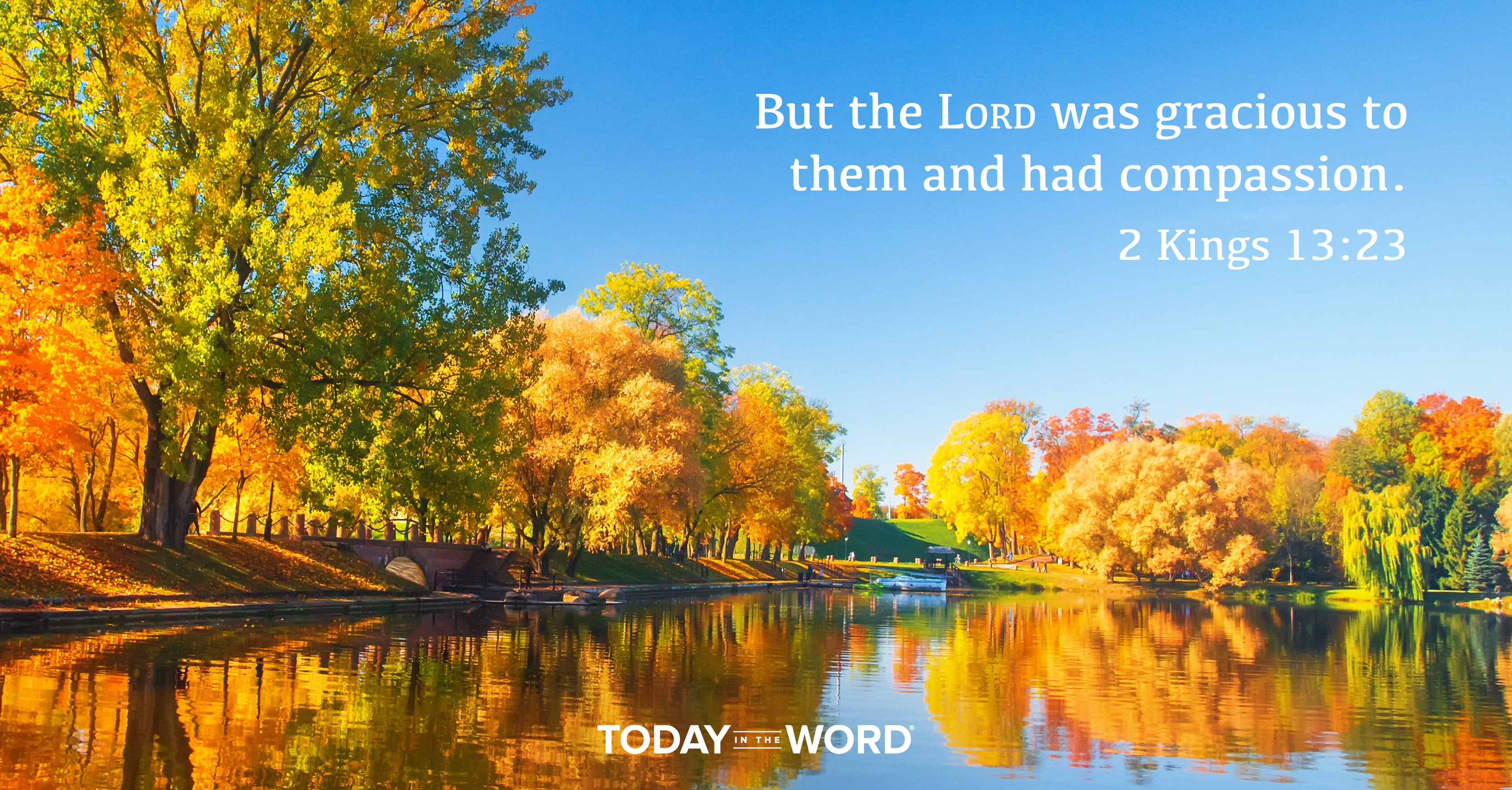 Today's daily devotional Bible verse: 2 Kings 13:23 But the LORD was gracious to them and had compassion. | Fall colored trees surrounding a lake.